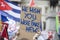 A protestor holds a political banner with you wish you were fake news message