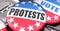 Protests and elections in the USA, pictured as pin-back buttons with American flag, to symbolize that Protests can be an important
