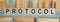 PROTOCOL word written on wooden blocks on light blue background