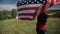 Proud american girl holding stars and stripes in slow motion