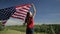 Proud american girl holding stars and stripes in slow motion