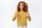 Proud, attractive lucky redhead curly girl in yellow sweater, got promoted, pointing herself, smiling delighted