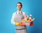 Proud cleaning woman with basket with detergents and brushes