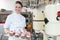 Proud confectioner showing muffins she baked