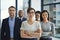 A proud, confident and diverse team of lawyers standing in an office or a law firm. Portrait of a happy and smiling