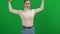 Proud confident slim woman making strength gestures at chromakey background looking at camera. Portrait of fit young