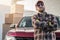 Proud Contractor Worker Next to His Pickup Truck and Cargo Boxes