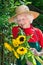 Proud elderly gardener admiring her flowers.