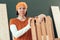 Proud female carpenter posing with finished wooden crate