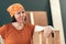 Proud female carpenter posing with finished wooden crate