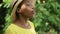 Proud happy African American woman smelling organic red strawberry in glass bowl smiling looking at camera. Portrait of