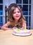 Proud little girl with birthday cake