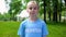 Proud little girl in volunteer t-shirt standing at park, environment protection