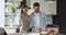 Proud loving young woman hugging watching beloved husband preparing meal.