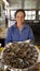 A proud oyster farmer shows off her production in Cap-Ferret, France