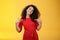 Proud and satisfied ambitious successful female student in red dress standing pleased smiling and pointing at herself as