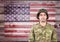 Proud soldier against wooden american flag background