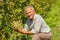 Proud viticulturist showing grape cluster