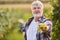 Proud winemaker shows vine of white grapes