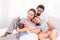 Proudly Asian man hug wife and 2 kids with love, care, protection, adorable daughter lie down on father`s bosom or chest looking