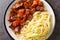 Provencal Beef Stew Daube served with noodles closeup in the plate. Horizontal top view