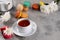 Provence breakfast. Bright french macarons , a cup of tea, a teapot. Grey background