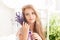 Provence. A close-up portrait of a pensive blonde little girl holding a fragrant bouquet of lavender by her face. The concept of c