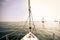 Prow of a yacht at sea with other yachts in the background in re