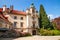 Pruhonice Castle main entrance with shrubs of blooming Rhododendrons