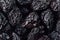 Prune close up background. Heap of glossy black prunes.