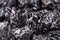 Prune close up background. Heap of glossy black prunes.