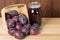 Prune plums with jar of jam