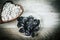 Prunes in a bowl and cereal on a wooden table