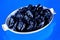 Prunes, healthy food â€” plum in dried form,dried fruit, on a blue background. In cooking prunes â€” sweet dessert, compote and