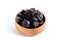 Prunes inside wooden bowl
