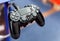 PS4 controller closeup, shallow depth of field. PlayStation 4 pad plugged in up close. Console gamepad, input devices concept