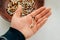 Psilocybin mushrooms in man`s hand, brown background. Psychedelic magic Golden Teacher mushrooms. Medical usage.