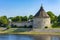 Pskov, Pokrovskaya tower and the wall of the Roundabout city on the banks of the Velikaya river, Sunny summer morning