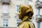 PSKOV, RUSSIA - March 10, 2019: living statue young woman painted in gold. Russian costume