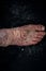 Psoriasis eczema on the foot Man itching skin Psoriasis scales are scattered on black background.