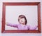 Psychological portrait of cute little child girl extending rules beyond the frame. Freedom concept