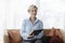 Psychologist Holding Folder Sitting On Sofa In Office