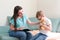 Psychologist listens to a small child during a therapy session