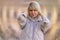 Psychology and mental health. Portrait of Caucasian adult woman holding at her head. Defocused twisted background