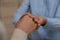 Psychotherapist holding patient`s hand indoors, closeup view