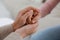 Psychotherapist holding patient`s hand indoors, closeup view