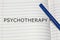 Psychotherapy word written on white paper, health concept background