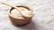 Psyllium husk in spoon on wooden bowl, fiber food for diet on linen table cloth background