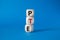 PTE - Pearson Tests of English symbol. Wooden cubes with word PTE. Beautiful blue background. Business and PTE concept. Copy space