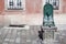 A public antique ancient well, drinking fountain. Column with drinking water along the city street, Old town